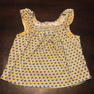 Baby’s yellow shirt with blue flowers